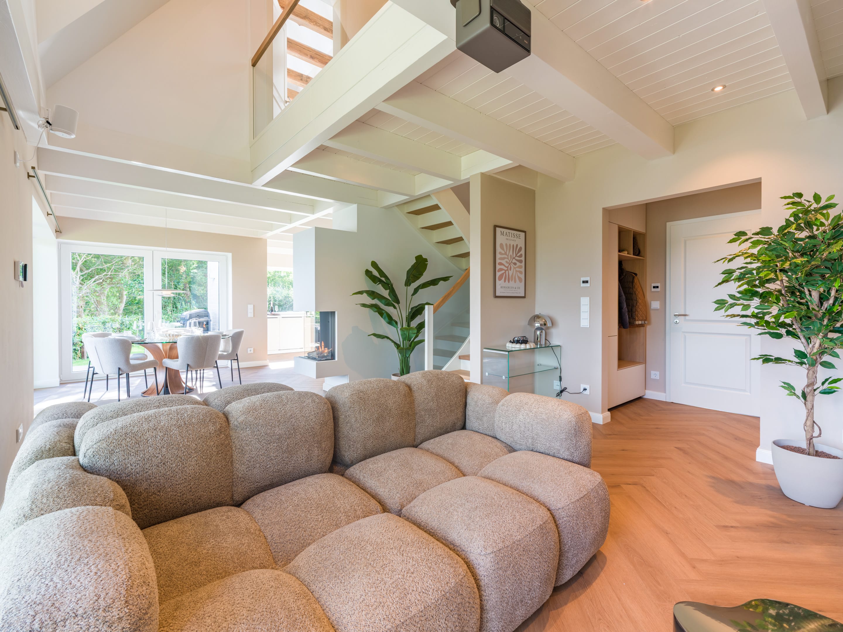Living room with sofa landscape, gallery and open beamed ceiling